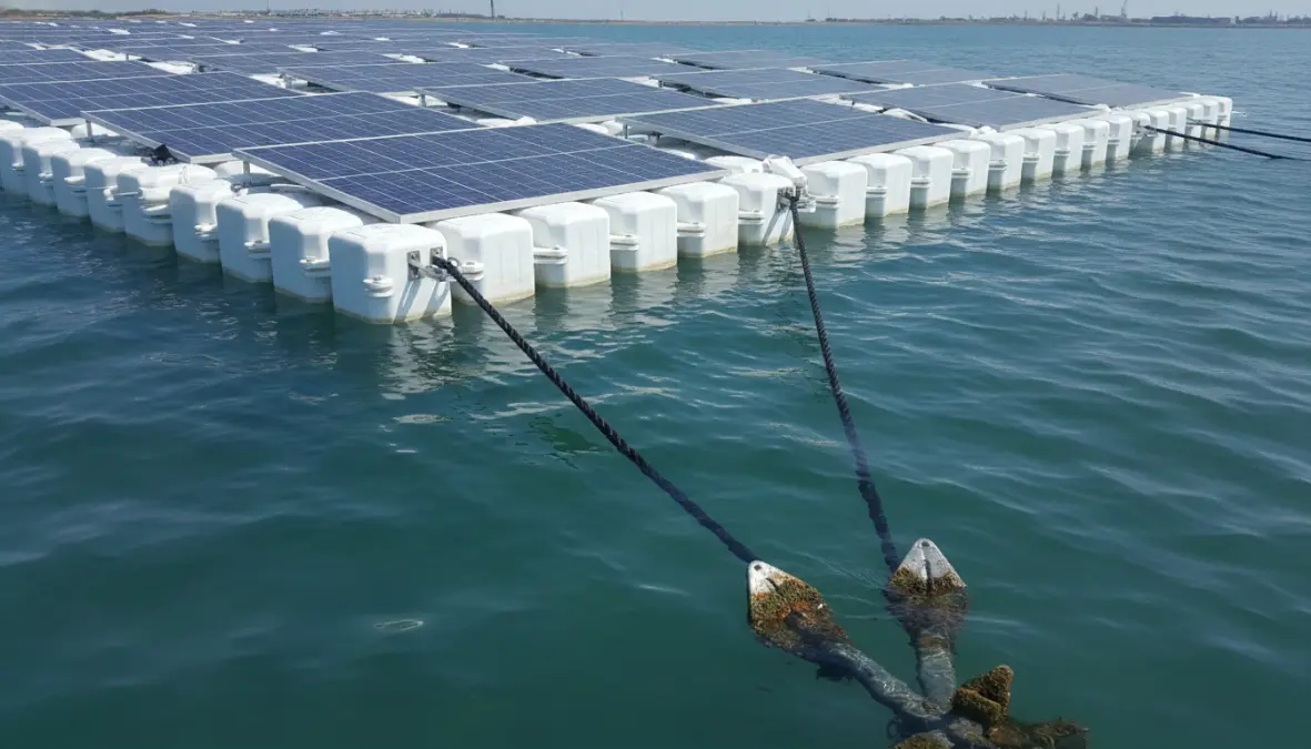 Close-up of floating photovoltaic system showing anchoring systems and floating solar panel structure on water